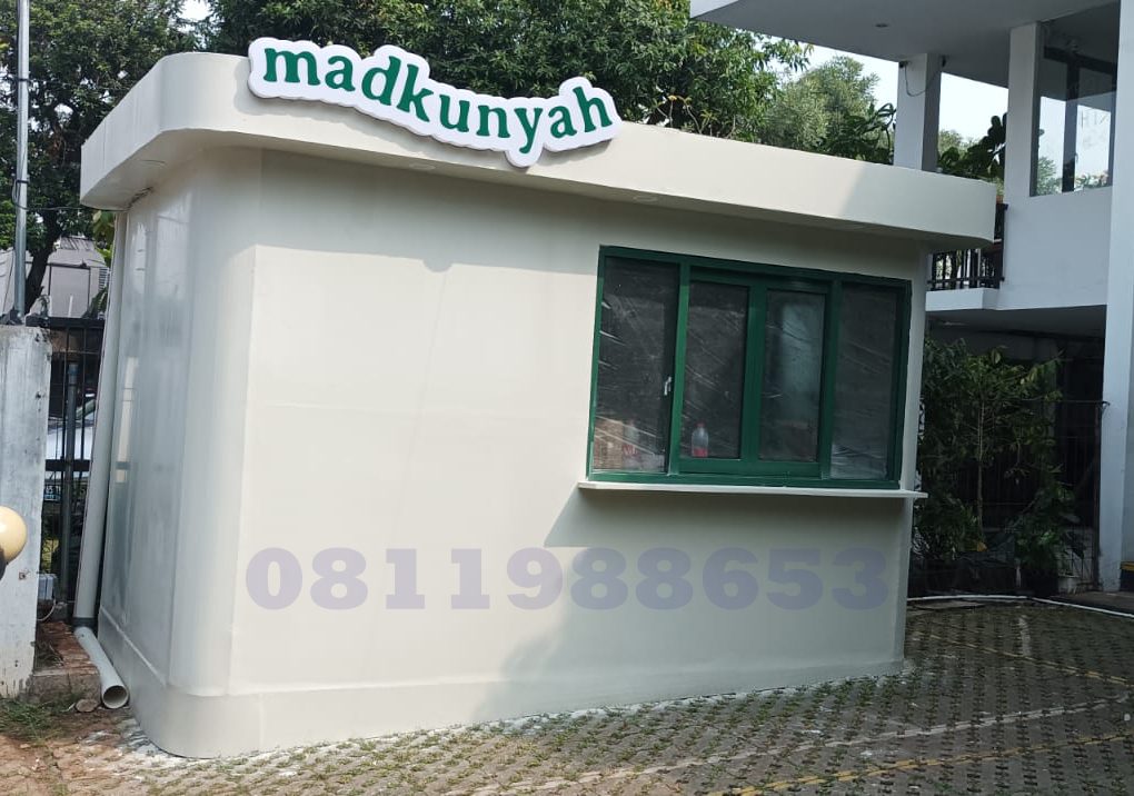 Huruf timbul akrilik Madkunyah dengan lampu LED putih terpasang pada fasad bangunan modern.