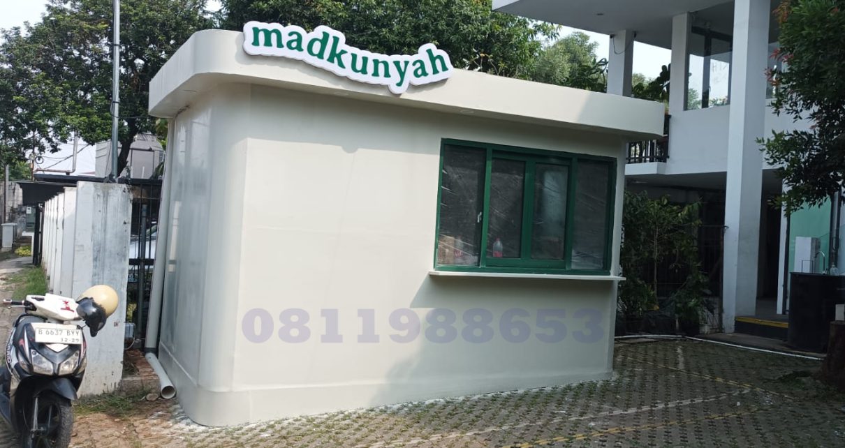 Huruf timbul akrilik Madkunyah dengan lampu LED putih terpasang pada fasad bangunan modern.